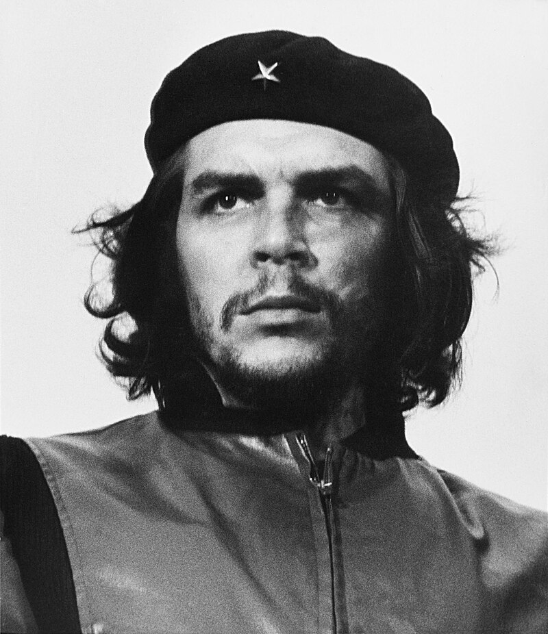 Black and white portrait of Che Guevara with a determined expression, wearing a beret with a star.